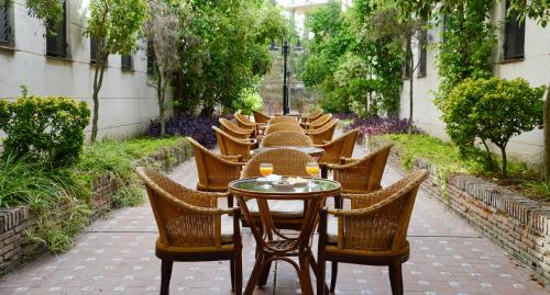 a row of tables and chairs in a courtyard at Hotel San Pablo Sevilla in Seville