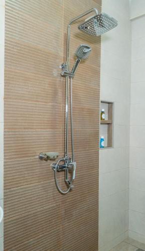 a shower with a shower head in a bathroom at Nguchiro Palace in Moshi
