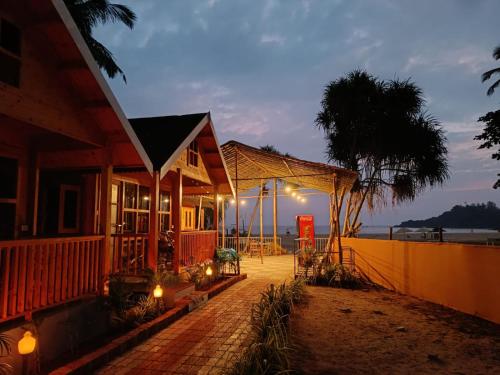 a house on the beach at night at Sand Tent Beach Resort Patnem in Patnem
