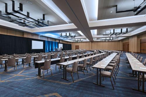 an empty lecture hall with tables and chairs at The Westin Irving Convention Center at Las Colinas in Irving