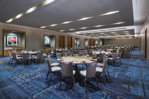 a banquet hall with tables and chairs in a room at The Westin Irving Convention Center at Las Colinas in Irving