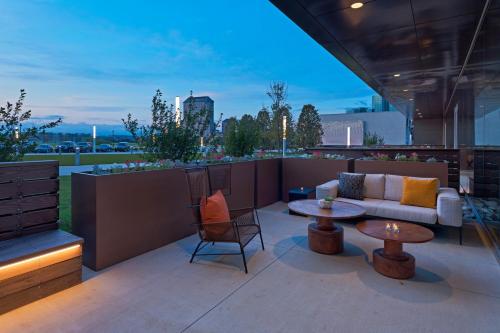 a patio with a couch and tables on a rooftop at The Westin Irving Convention Center at Las Colinas in Irving