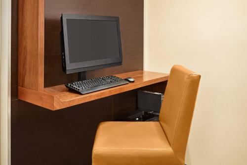 a desk with a computer monitor and a keyboard at TownePlace Suites by Marriott Chattanooga Near Hamilton Place in Chattanooga