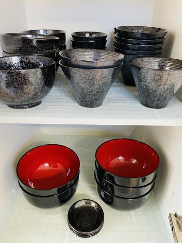 two shelves of pots and pans in a refrigerator at Ocean Terrace金武 in Kin