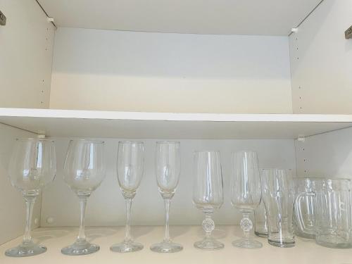 a row of wine glasses sitting on a shelf at Ocean Terrace金武 in Kin