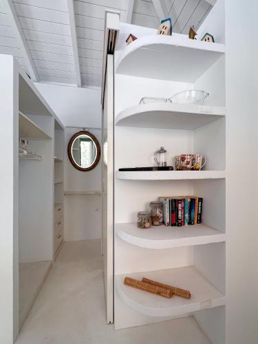 a kitchen with white shelves and a refrigerator at Panta'kei in Stavros
