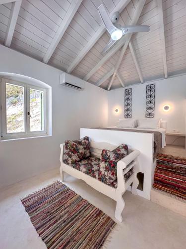 a living room with a couch and a ceiling fan at Panta'kei in Stavros