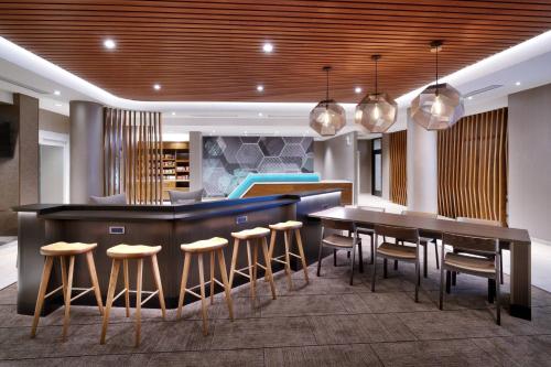 a kitchen with a bar and a dining room at SpringHill Suites by Marriott El Paso Airport in El Paso