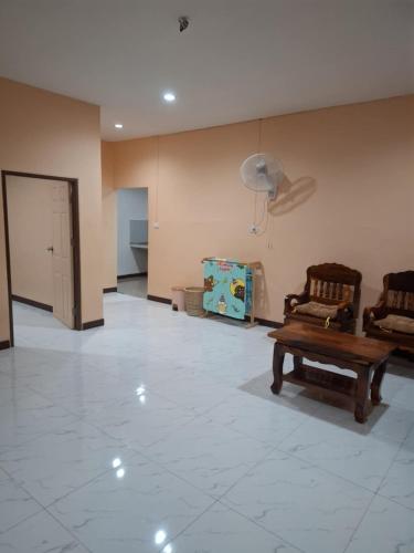 a living room with two chairs and a couch at Patcharin house 1 in Ko Lanta Yai