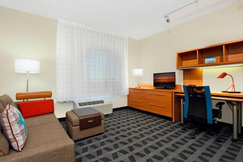 an office with a couch and a desk with a computer at TownePlace Suites by Marriott Dallas McKinney in McKinney