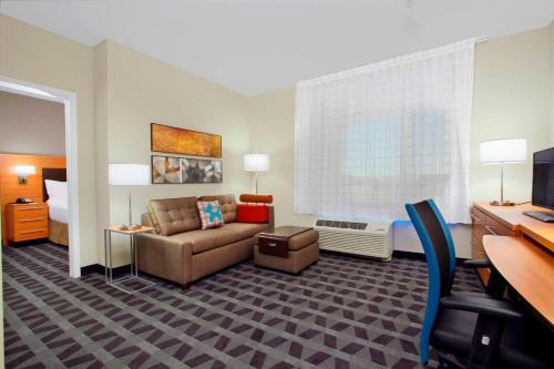 a hotel room with a couch and a bed at TownePlace Suites by Marriott Dallas McKinney in McKinney