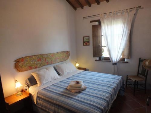 a bedroom with a bed with a stuffed animal on it at Fonte Pecciano 1856 in Casamaggiore