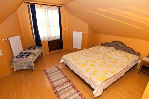 a bedroom with a large bed in a room at Sas-Fészek Vendégház in Demjén