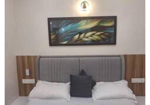 a painting above a bed in a bedroom at Raghav Vilas - Essence of Kashi in Varanasi
