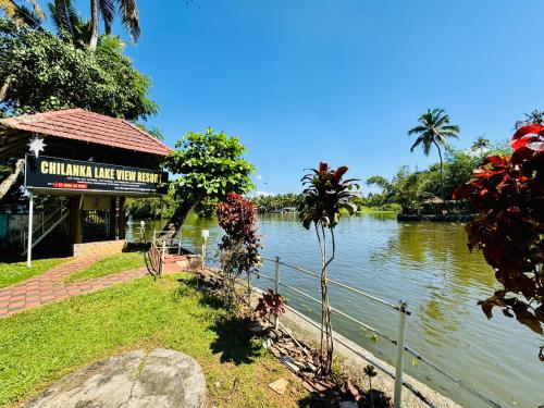 a sign for a restaurant next to a river at Chilanka Lake View Resort in Alleppey