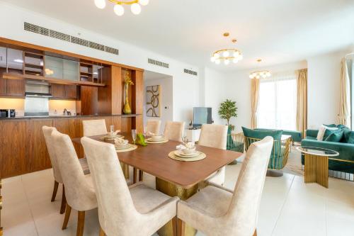 a dining room and living room with a table and chairs at INA Homes-Residences Tower 7 Full Burj Khalifa & Fountain Views in Dubai