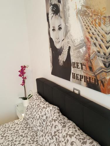 a painting above a bed in a bedroom at H5-5H Luxury Room in Maranello