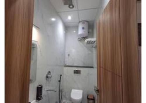a bathroom with a toilet and a sink and a mirror at Raghav Vilas - Essence of Kashi in Varanasi