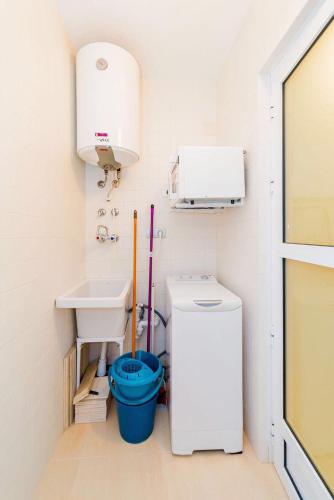 a small bathroom with a sink and a toilet at Шикарная квартира на первой линии -Luxury apartment on the first line sea in Torrevieja