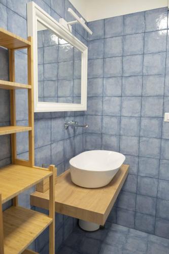 a bathroom with a white sink and a window at Il Pendio B&B in Bisceglie