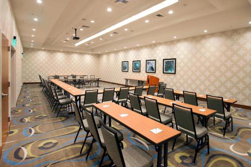 a row of tables and chairs in a room at SpringHill Suites by Marriott Wilmington Wrightsville Beach in Wilmington