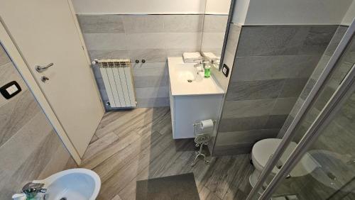 a bathroom with a sink and a toilet and a shower at Sweet Escape Roma in Rome