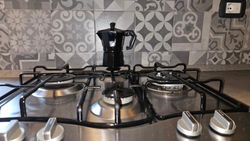 a stove top with two pots on top of it at Sweet Escape Roma in Rome
