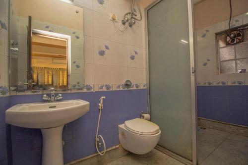a bathroom with a toilet and a sink at Hotel O Ghakhel in Ravangla