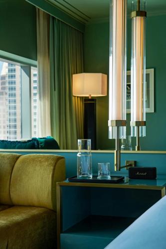 a hotel room with a couch and a table with glasses on it at W Austin in Austin