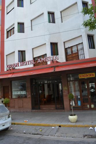 a white building with a sign for a hotel at Gran Hotel Amelia in Mar del Plata