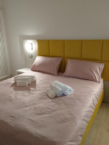 a bed with two towels on top of it at Hotel Garden in Levico Terme