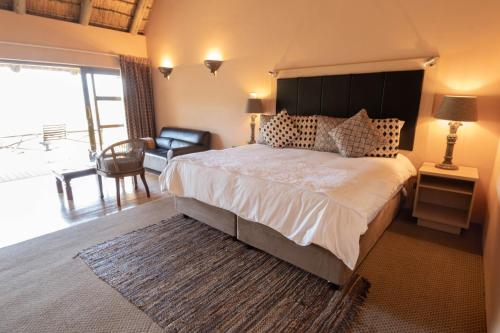 a bedroom with a large bed and a chair at Little Switzerland Resort by Dream Resorts in Ethels Drive
