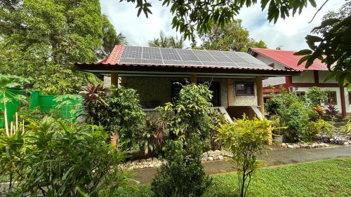 a house with solar panels on the roof at Haus am Strand auf Sibuyan Island nahe Cresta de Gallo - Marevic's Guesthouse 1 ohne Klimaanlage in Azagra