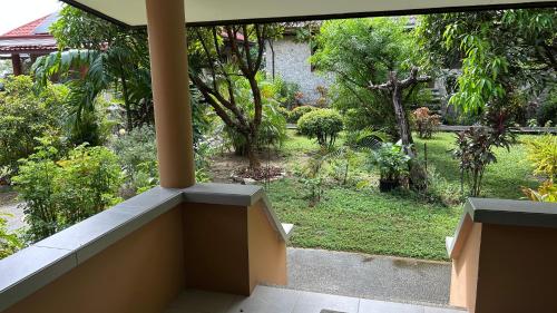 a view of a garden from the balcony of a house at Haus am Strand auf Sibuyan Island nahe Cresta de Gallo - Marevic's Guesthouse 1 ohne Klimaanlage in Azagra
