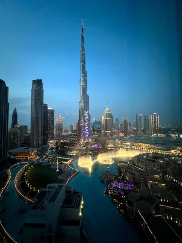 a view of a city skyline at night at INA Homes-Residences Tower 7 Full Burj Khalifa & Fountain Views in Dubai