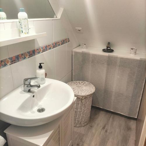 a white bathroom with a sink and a mirror at Casa del bienestar in Bermeo
