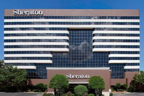 an office building with a sheraton sign on it at Sheraton DFW Airport Hotel in Irving