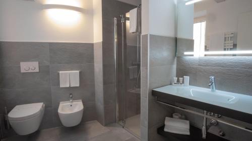 a bathroom with a toilet and a sink and a shower at Bed and Breakfast Casa Mosole in Malcesine