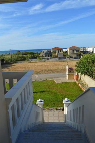 a stairway leading to a house with a yard at Maleme ocean front serenity in Ayiá