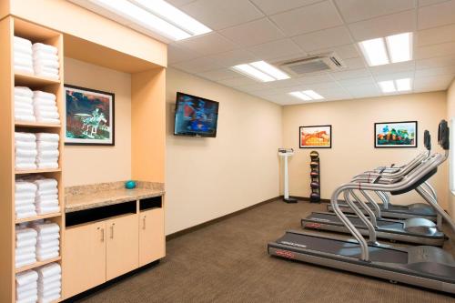 a fitness room with a treadmill and towels at TownePlace Suites by Marriott Lexington South/Hamburg Place in Lexington