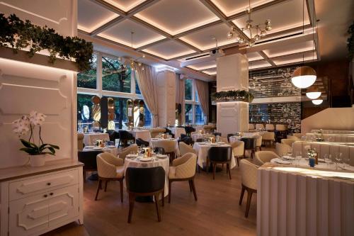 a restaurant with tables and chairs in a room at W Dallas in Dallas