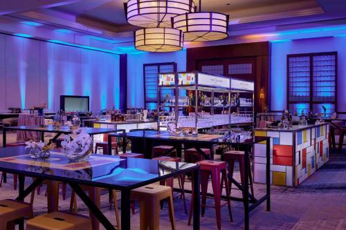 a dining room with tables and chairs and lights at Sheraton Phoenix Downtown in Phoenix