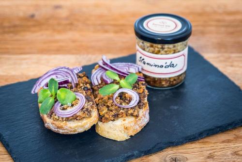 a piece of bread with onions and a jar of spices at Továrna Vír in Vír