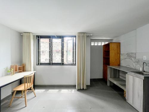 a kitchen with a sink and a desk and a window at Timmy's house in Ho Chi Minh City