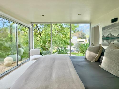 a large bedroom with a large bed and large windows at The Glass House Montecito in Santa Barbara