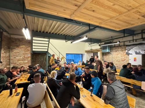 a large group of people sitting at tables in a room at Továrna Vír in Vír