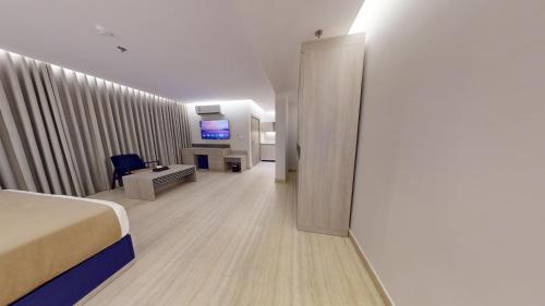 a hotel room with a bed and a living room at فندق المستراح - Al Mustarah Hotel in Al Madinah