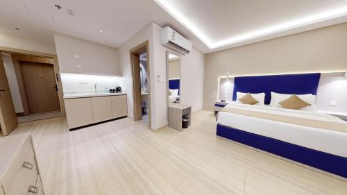 a hotel room with a large bed and a bathroom at فندق المستراح - Al Mustarah Hotel in Al Madinah