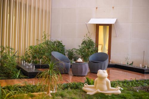 a teddy bear sitting on the ground in a garden at ELIVAAS Prive 5 BHK Kvanya Mansion with Pvt Pool & Home Theater in Debāri