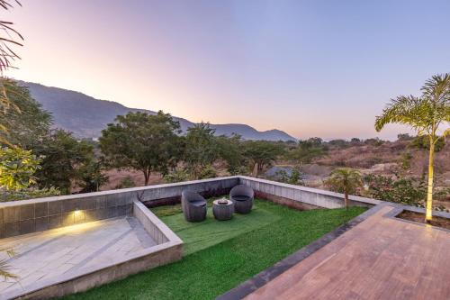 a garden with a view of the mountains at ELIVAAS Prive 5 BHK Kvanya Mansion with Pvt Pool & Home Theater in Debāri